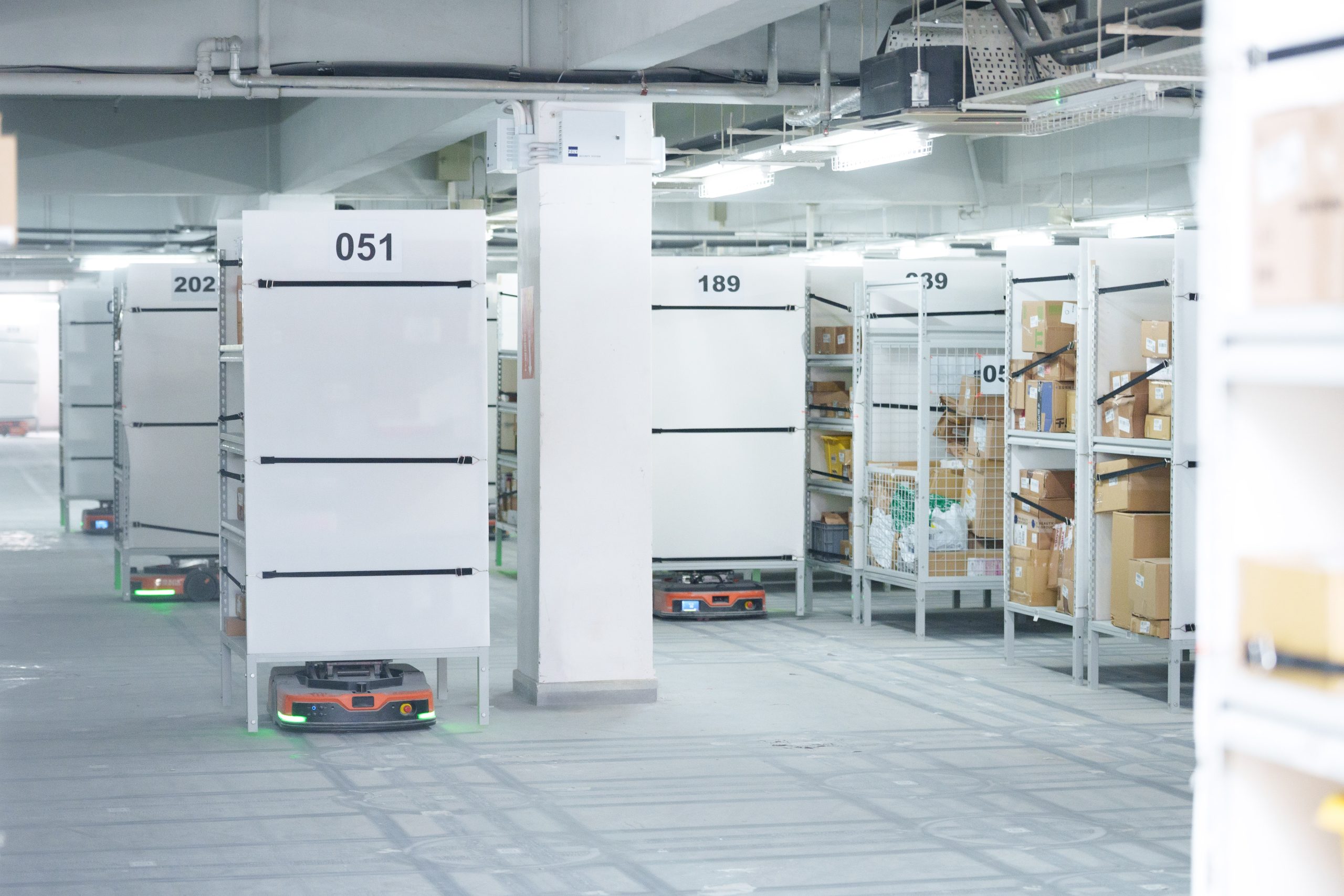 A robotic storage rack moving along a warehouse aisle